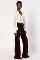 ANNA BURGUNDY MONOGRAM FLARED VELVET TROUSERS